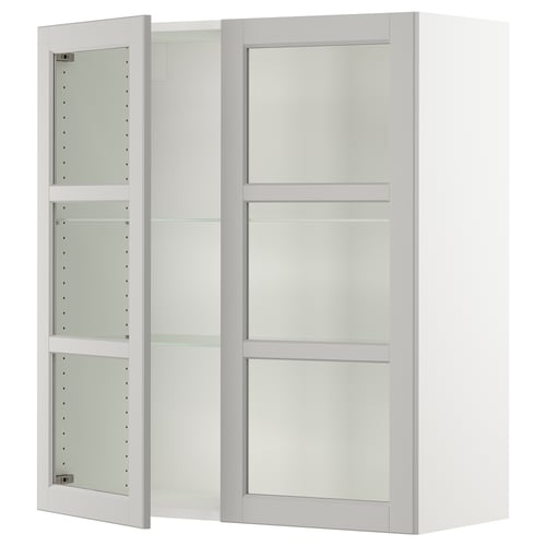 White SEKTION kitchen cabinet with glass doors and adjustable shelves.
