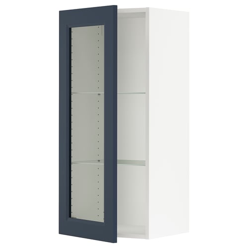 A blue ikea SEKTION kitchen wall cabinet with glass doors and metal hinges.
