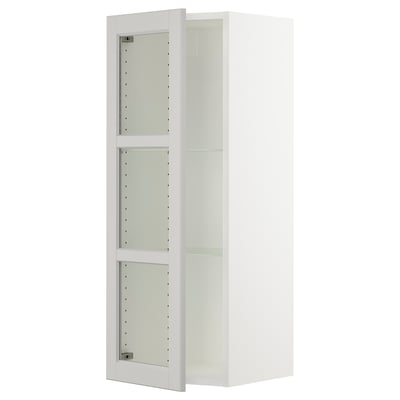 White SEKTION kitchen cabinet with glass doors and metal hinges.