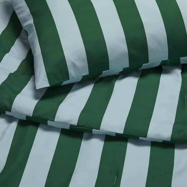 Soft, striped green and white comforter set with recycled materials, neatly folded.
