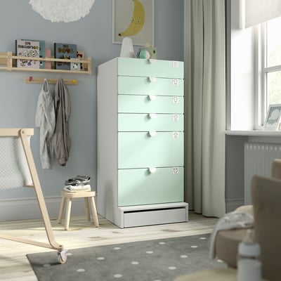 A SMÅSTAD light green chest of drawers with six drawers in a childs room.