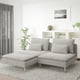 Modern living room with SÖDERHAMN sectional, minimalist decor, globe lamp, plant, speckled rug.
