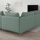 Green IKEA SÖDERHAMN corner sofa with slim lines and deep seats. Modern, cosy space with plant and artwork.