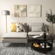 Modern living room with grey SÖDERHAMN sectional sofa, black coffee table, colourful pillows, abstract paintings, and floor lamp.