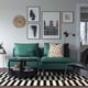 Modern living room with teal SÖDERHAMN sofa, black & white chequered rug, colourful pillows, and wall art.