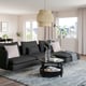 Modern living room with large black SÖDERHAMN sectional sofa, soft pillows, stylish lamp, and large window offering city views.