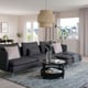 Modern living room with SÖDERHAMN dark grey sectional sofa, decorative pillows, black coffee table, large windows, and hanging light fixture.