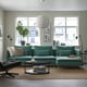 Modern living room with teal SÖDERHAMN sofa, soft fabric, windows, rug, coffee table, side chair.