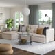 Modern living room with light beige SÖDERHAMN sectional sofa, glass coffee table, large rug, and grey curtains. Bright, cosy, and spacious.