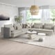 Modern living room with SÖDERHAMN sectional, light wood floor, unique pendant light, coffee table, green plant, and mountain art.
