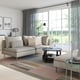 Modern living room: creme SÖDERHAMN sofa, grey lamp, coffee table, striped rug, large window with grey curtains, nature view outside.