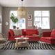 Bright red SÖDERHAMN sofa set, modern & low-profile, with cushy back & seat, paired with a wooden coffee table, stylish against large windows.