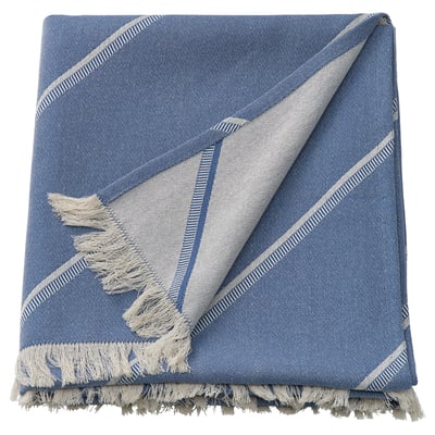 Blue striped blanket with fringes. Modern geometric design. Made of cotton and lyocell. Rectangular shape.