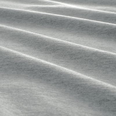 Close-up of soft, knitted jersey fabric, showcasing its woven texture and gentle folds.
