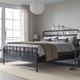 STJÄRNÖ black bed, nightstands, pendant light, large window.