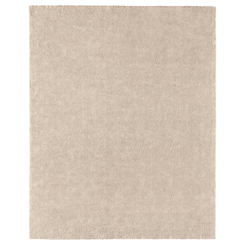 A STOENSE rug in light beige. Its rectangular, soft, and has a subtle sheen. Made of polypropylene, its comfortable and durable.