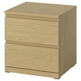 Light-colored wooden bedside table with two drawers, sleek design.