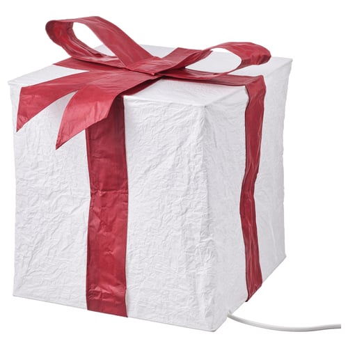 STRÅLA, white glowing cube lamp, red ribbon, paper, warm light.