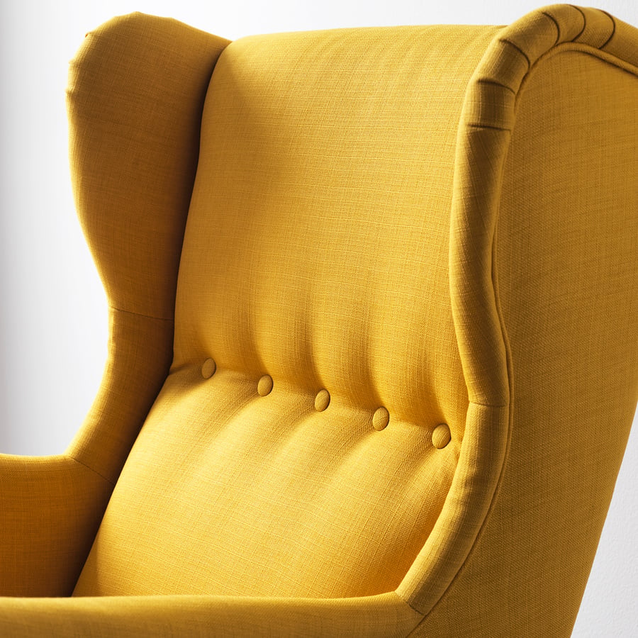 Close-up of yellow fabric chair. High back, detailed stitching, comfortable padding. Eco-friendly recycled materials.