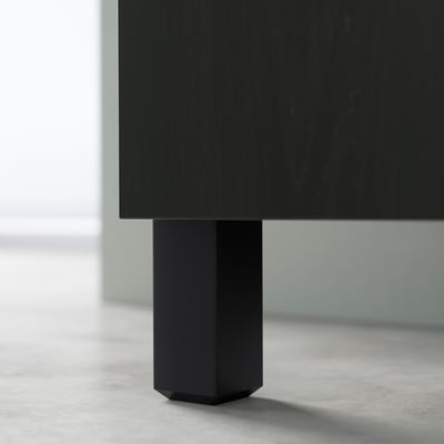 Black hexagonal table leg supporting flat surface, part of STUBBARP series, adjustable, stylish, and stable.