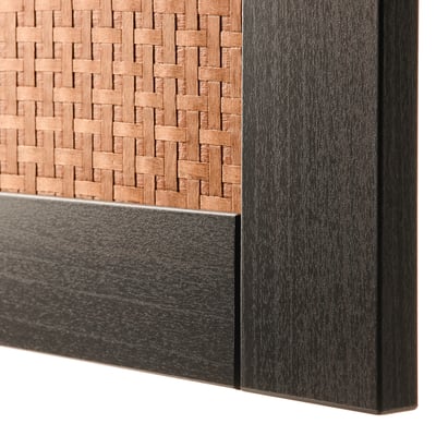Close-up of woven wooden panel, dark frame, smooth black base.