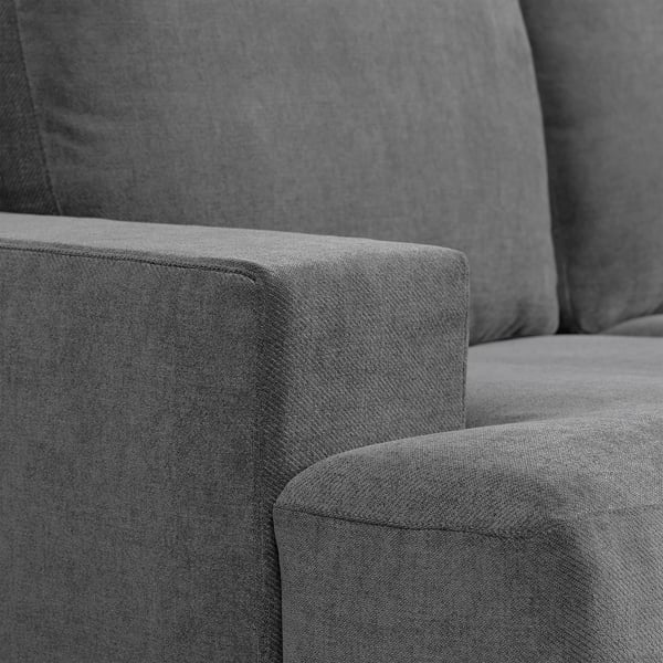 Close-up of a modern, grey, upholstered sofa with plush cushions, showcasing quality fabric and design.