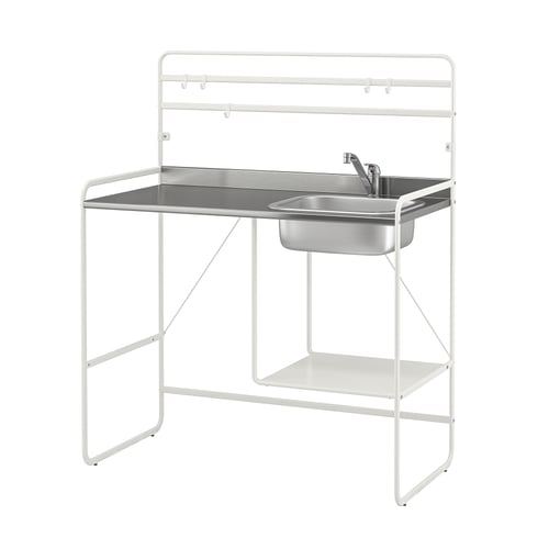 A white SUNNERSTA mini-kitchen with a stainless steel sink and shelf. The frame is metal with adjustable feet.