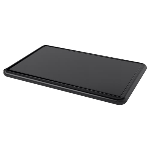 Black rectangular chopping board with smooth surface and groove around the edge. Made of durable polyethylene plastic.