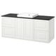 The tannforsen vanity is white with a black countertop, featuring drawers and cabinets. It has a rectangular sink.