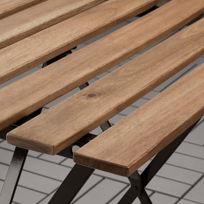 Wooden slatted bench seat with metal frame, showcasing durable craftsmanship.