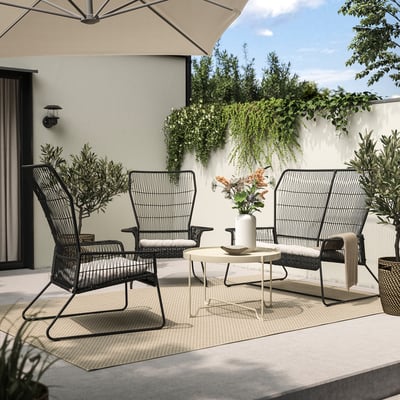 Modern outdoor seating set with two black wicker chairs and a small table, perfect for relaxation.