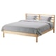 A TARVA bed with a light wooden frame, grey bedding, and two pillows. It a simple, scandinavian design.