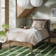 Modern bedroom with TONSTAD light oak bed, pendant lights, plant, and slippers.