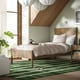 Cosy bedroom with TONSTAD bed, light brown frame, green rug, white pillows, stylish pendant light.