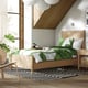 Modern bedroom with TONSTAD bed, green tropical bedding, large window, striped rug, chair, plant.
