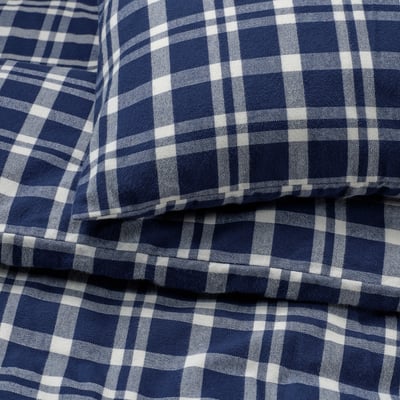 Blue and white chequered flannel fabric close-up. Soft, durable, and warm, its perfect for cosy nights.