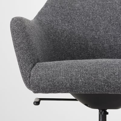 Close-up of tozzberg swivel chairs cushioned seat & back, upholstered in durable fabric, showcasing comfort & quality.
