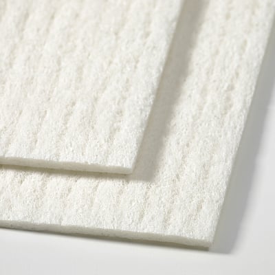 Close-up view of stack of white, textured cleaning cloths, showing soft, absorbent material.