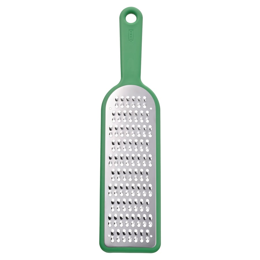 Green kitchen grater with stainless steel surface and green plastic handle for gripping and storing.