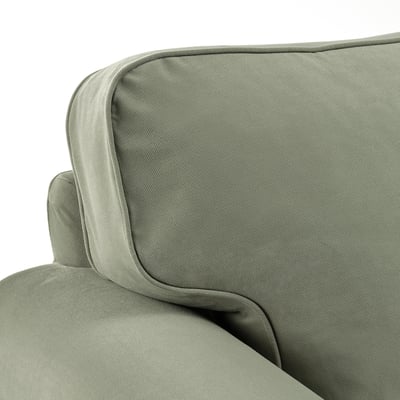 Close-up of UPPLAND armchairs soft, durable, and smooth green fabric, showcasing its high-quality stitching and comfortable padding.