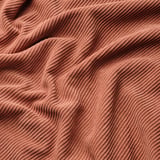 Rust-colored, soft, durable fabric with wavy texture, likely kelinge polyester, hinting at comfort and quality.