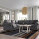 Grey UPPLAND sectional sofa in modern living room with coffee table, rug, and window curtains.