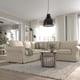 Beige UPPLAND sofa in modern living room with cushions, rug, coffee table, and striped pillows. Bright, airy ambiance with white curtains.