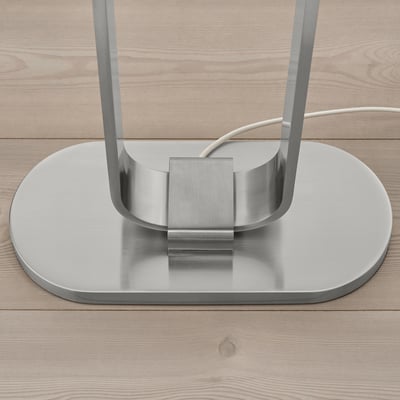 Modern metallic floor lamp base with sleek design and reflective surface.