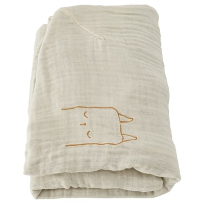 Folded beige organic cotton baby blanket with small embroidered cat design, soft and eco-friendly.