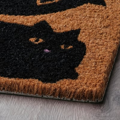 Halloween-themed doormat with bats, made of durable coir.