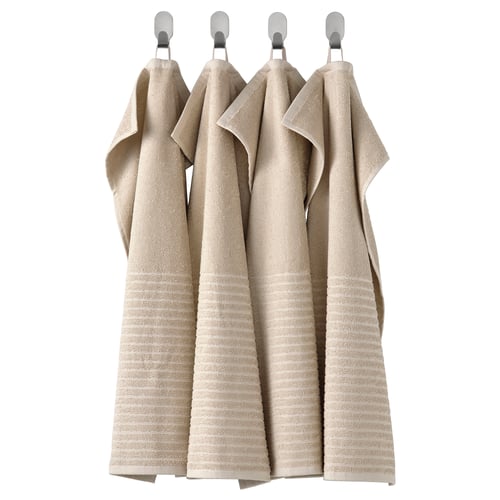 Four light beige cotton towels hang neatly in a row, each with a linear rib texture, attached by silver hooks.