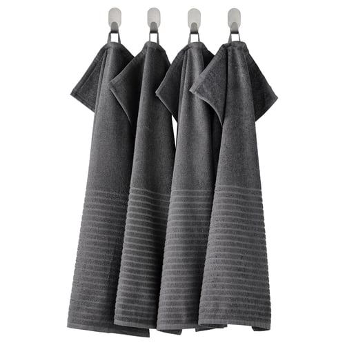 Four dark grey VÅGSJÖN towels hang neatly in a row, each with a ribbed texture and folded at the top, made of soft cotton.