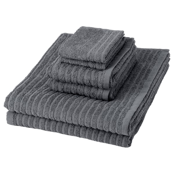 Six grey cotton towels stacked neatly, featuring a textured, striped pattern.