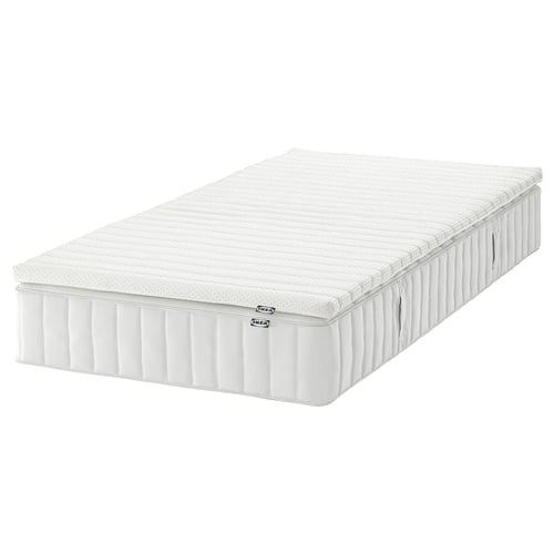 A white IKEA VALEVÅG pocket spring mattress with a quilted top, rectangular shape, and plush design, perfect for side and back sleepers.